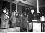 The one millionth German resettler of Wartheland speaking at a ceremony, Posen, Germany, 16 Mar 1944; Arthur Greiser and Walter Petzel in background