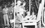 Admiral William Halsey, Major General Robert Beightler, Major General Roy Geiger, and others studying a map at US 37th Division command post on Bougainville, Solomon Islands, Nov-Dec 1943
