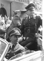 German Minister of Armaments Albert Speer (front) and Field Marshal Erhard Milch (rear) in an automobile en route to inspect a defense plant, Germany, May 1944