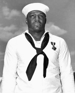 Doris Miller wearing the the Navy Cross medal, having just been awarded from Admiral Chester Nimitz, onbard carrier Enterprise, Pearl Harbor, US Territory of Hawaii, 27 May 1942