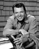 Audie Murphy as his character Tom Smith from the television show Whispering Smith, 1959