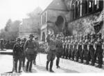 Adolf Hitler welcomed by a honor guard at Goslar, Germany, 30 Sep 1934; note Captain Erwin Rommel in background