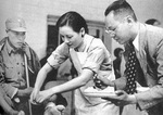 Song Meiling helping with bandaging a wounded Chinese soldier, circa 1932