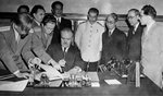 Vyacheslav Molotov signing the Sino-Soviet Treaty of Friendship and Alliance, Moscow, Russia, 14 Aug 1945; note Song Ziwen and Joseph Stalin in background