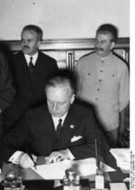 Ribbentrop signing the German-Soviet non-aggression pact, Moscow, Russia, 23 Aug 1939, photo 2 of 3; Molotov and Stalin in back row