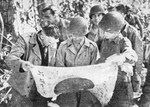General Joseph Stilwell inspecting a recently captured Japanese flag, Burma, 1942