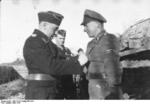 SS-Sturmbannführer Schöneberger and SS-Obersturmbannführer Max Wünsche (background) awarding a man under their command, near Kharkov, Ukraine, Mar 1943