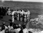 US Navy Chaplain W. M. Dunn conducting funeral service of Lieutenant (jg) Eugene Bradshaw aboard USS Coral Sea in the Pacific Ocean during the Mariana Islands campaign, 19 Jun 1944