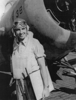 Lieutenant J. P. Weinel posing with a FM-1 Wildcat fighter aboard USS Coral Sea, 30 Oct 1943