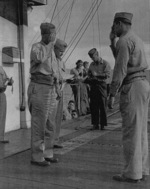 Captain George C. Montgomery awarding the Air Medal to Lieutenant (jg) P. B. Wyser aboard USS Anzio, 6 Jan 1945