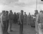 Captain George C. Montgomery awarding a citation ribbon to Aviation Ordnanceman 2nd Class Harvey J. Rowe aboard USS Anzio, 6 Jan 1945, photo 2 of 2