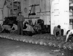 Men fusing bombs aboard USS Anzio, 20 Apr 1945
