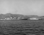 HMS Belfast in the channel at Busan, Korea, 2 Apr 1952; note hospital ship USS Consolation