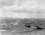 Battleship Bismarck burning in the distance as seen from a British warship, 27 May 1941