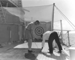 Eisenhower practicing golf aboard USS Canberra while en route to Bermuda, 14 Mar 1957