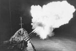 Guided missile cruiser Canberra firing a salvo in the Gulf of Tonkin at night at a North Vietnamese target, Mar 1967