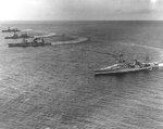 Louisville, Salt Lake City, Northampton, and Chicago turning in formation with three other Scouting Force heavy cruisers to create a slick for landing seaplanes, off Pearl Harbor, Hawaii, 31 Jan 1933