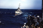 Destroyer Cotten steaming at sea, circa 1945, photo 6 of 7; men of APA Sanborn in foreground