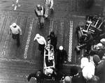 Wounded by aircraft gunfire, Aviation Ordnanceman Second Class Clifton R. Bassett of VB-3 was carried down the flight deck of Enterprise, 4 Jun 1942, photo 2 of 2