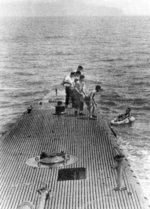 Crew of USS Finback pulling downed airman Lieutenant (jg) George Bush from the water off Chichi Jima, Bonin Islands, 2 Sep 1944