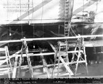 USS Helena in drydock at Pearl Harbor Navy Yard, US Territory of Hawaii, 13 Dec 1941, photo 2 of 2; note torpedo damage between frames 69 1/2 and 80 1/2 on starboard side