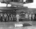 Funeral service on the fantail of the USS Honolulu on 7 Jul 1943 for F1c Irvin Edwards, a USS Helena crewman who died of his wounds. RAdm Walden Ainsworth stands with other Helena crewmen. Photo 2 of 2.