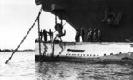 USS Holland preparing to hoist USS S-4 by the bow in preparation for repair work, 1920s