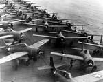 F4F-4 Wildcat fighters and SBD Dauntless dive bombers being prepared to launch from the flight deck of USS Hornet, off Midway, 4 Jun 1942