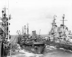 Battleship USS Iowa and carrier USS Shangri-La receiving fuel from oiler USS Cahaba, 8 Jul 1945. Photo 2 of 5.