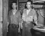Two survivors of the sunken Jintsu, dressed in US Navy uniforms, aboard USS Nicholas (DD-449), 13 Jul 1943