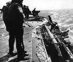 Damage to Lexington port side number six 5-in gun by dive bomb, Battle of Coral Sea, 8 May 1942, photo 1 of 2