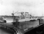 USS Lexington fitting out at the Bethlehem Steel Company shipyard at Quincy, Massachusetts, Nov 1927; note merchant ship West Grama at right edge of photo