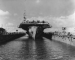 USS Makin Island entering floating drydock ABSD-6 for repairs and paint at Guam, Mariana Islands, 8 Jun 1945