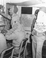 Crew members of USS Makin Island at their battle stations with inflatable belts and flash proof clothing, late 1944-mid 1945