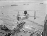 Walrus seaplane being launched from HMS Mauritius, date unknown, photo 1 of 2