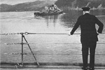 Winston Churchill on the deck of HMS Prince of Wales watching the USS McDougal as the ship transported Roosevelt back to the USS Augusta, 10 Aug 1941