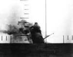 Japanese cargo ship Nittsu Maru sinking in the Yellow Sea, off China, after being torpedoed by American submarine USS Wahoo, 23 Mar 1943; photo taken from Wahoo