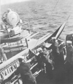 Signalmen hoisting and stowing signal flags aboard USS North Carolina, 22-31 Aug 1941
