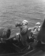 Aboard USS Phoenix, US Navy Rear Admiral Russell S. Berkey spoke to HMAS Australia or Shropshire via an eletric megaphone during the bombardment of Corregidor, Luzon, Philippine Islands, 15 Feb 194