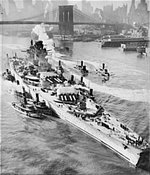 French battleship Richelieu, maneuvered by tugboats, arriving in New York, New York, United States for repairs, early 1943