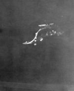 View from a USAAF B-17 bomber of Japanese destroyers Amatsukaze (bottom, sailing at speed) and Tokitsukaze (right, slowly backing away from the carrier) evacuating crew of the disabled carrier Ryujo (center, immobile), Battle of the Eastern Solomons, 24 Aug 1942, photo 3 of 3