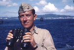 Ensign Louis Victor Shepard holding binoculars aboard Sanborn, 1945