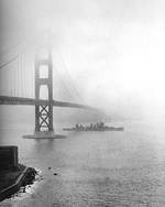 USS San Francisco under Golden Gate Bridge en route to Mare Island Navy Yard for repairs, San Francisco, California, United States, 11 Dec 1942