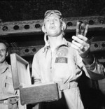 US Navy pilot Commander Joseph Clifton celebrating a successful raid on Rabaul, New Britain aboard USS Saratoga, 5 Nov 1943