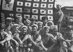 Crew of USS Snook holding up the submarine