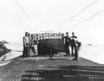Crew of USS Snook holding up the submarine