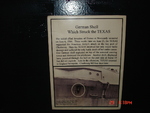 Plaque above the German shell that hit battleship Texas in Jun 1944, 2007; note the picture of the hole-the shell came in upside-down and landed in a warrant officers