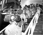Japanese-American members of US 442nd Regimental Combat Team walking down the gangplank of Victory Ship USS Waterbury Victory, Honolulu, US Territory of Hawaii, 9 Aug 1946, photo 1 of 2