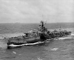 British Royal Navy T-class destroyer, probably HMS Terpsichore (D48), sailing alongside USS Wasp (Essex-class) of US Navy Task Group 38.3 off Japan Aug 1945; note USS Randolph in background