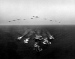 USS Wasp in formation with Gearing-class destroyers, S2F aircraft, AD-5W aircraft, and HSS-1 helicopters of Task Group Bravo, Mediterranean Sea, 19 Aug 1961
